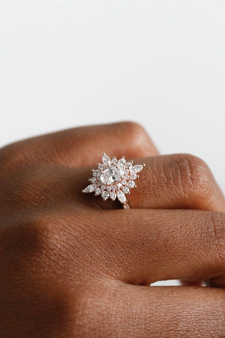 a woman's hand with a diamond ring on it