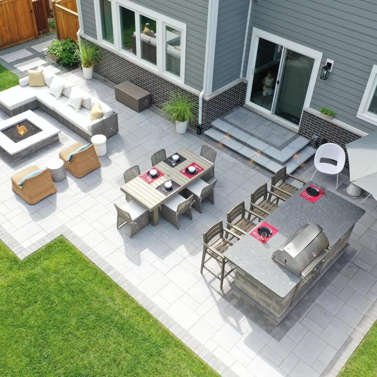 an aerial view of a patio with seating and fire pit in the back yard area