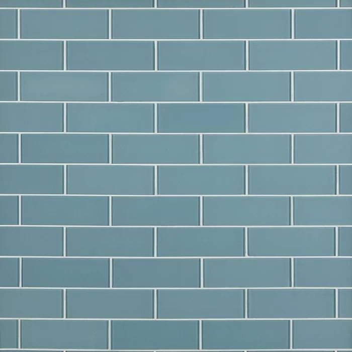 a white toilet sitting in front of a blue brick wall