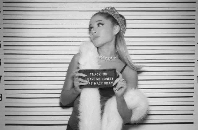 a woman holding a sign in front of a jail cell