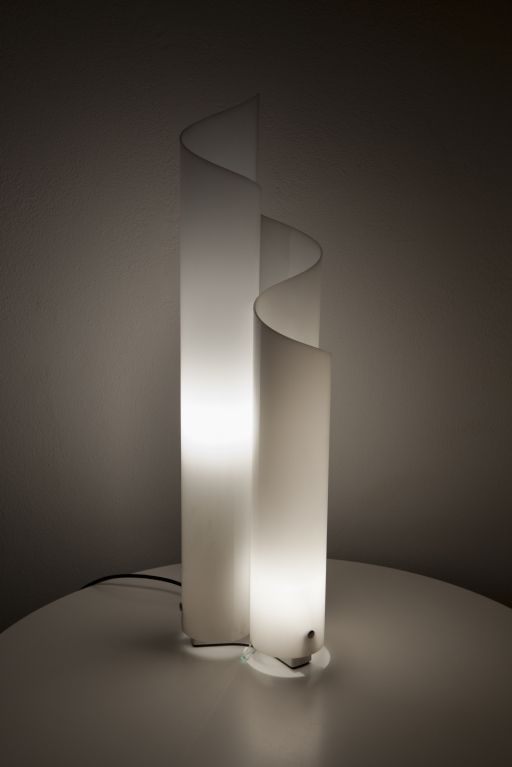 a white lamp sitting on top of a table