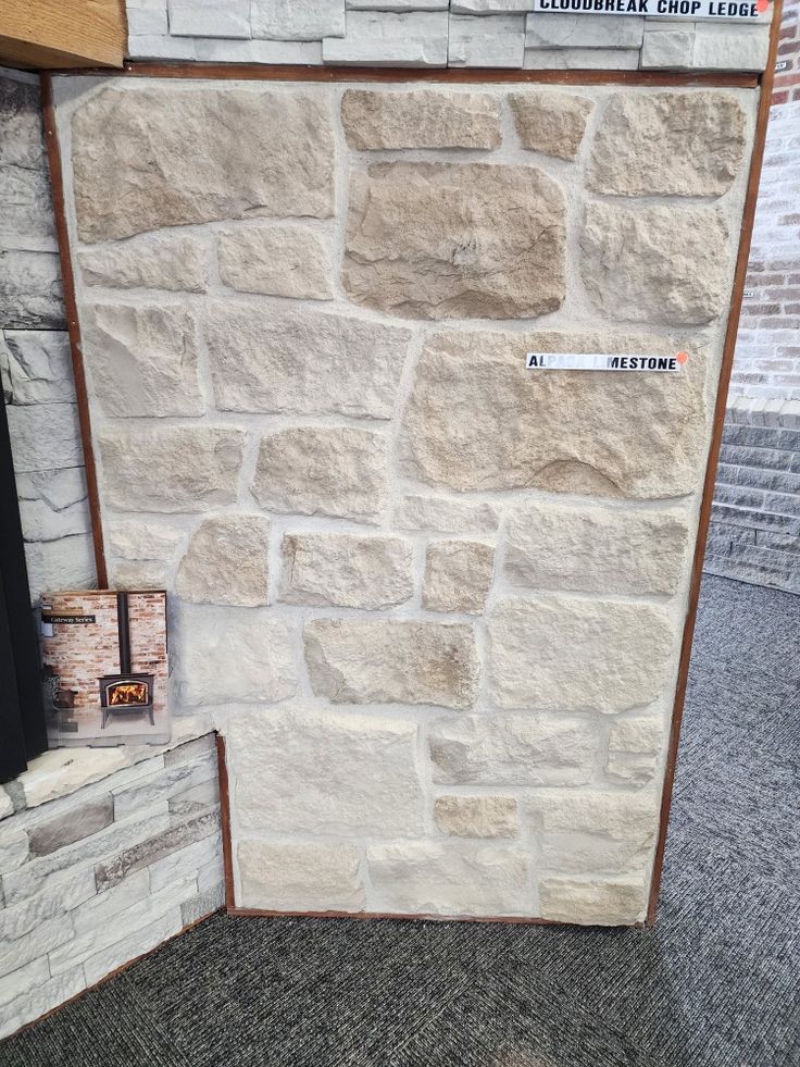 a stone wall is shown with some signs on the front and back walls, as well as an open fire hydrant next to it