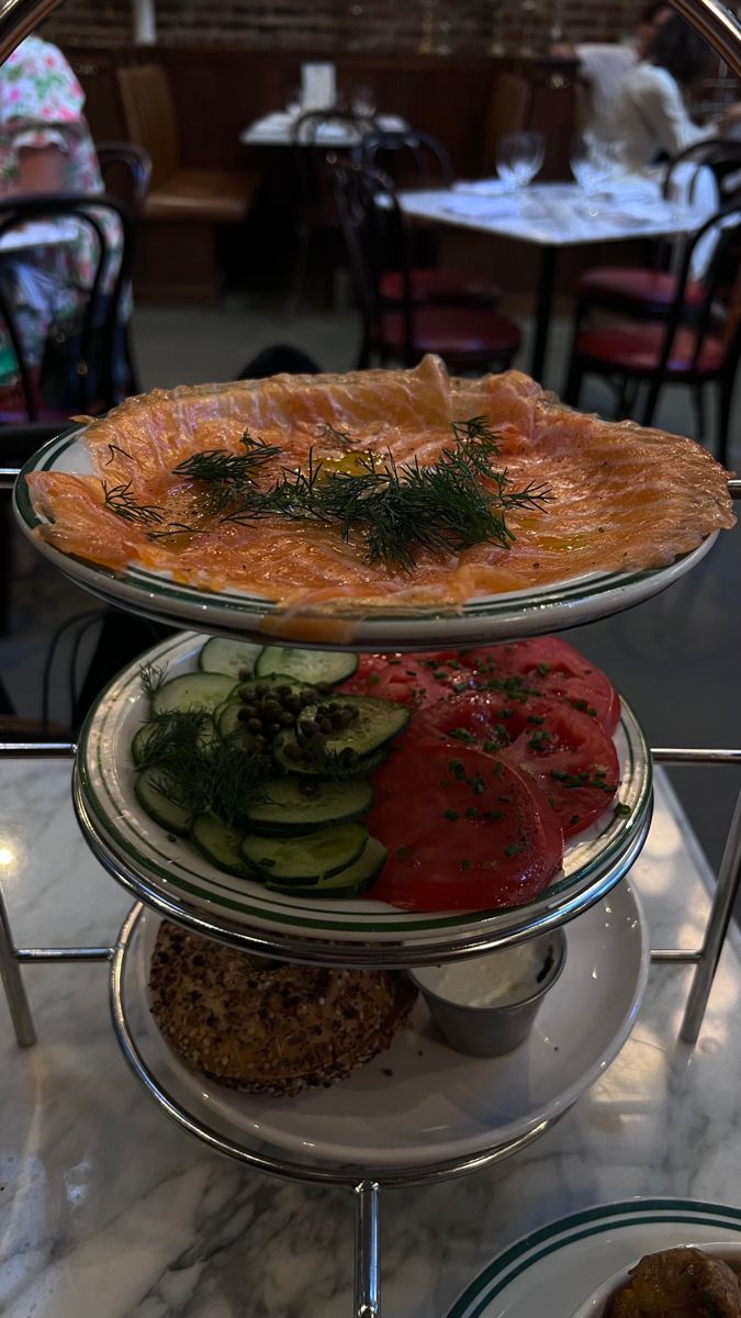 three tiered trays filled with different types of food