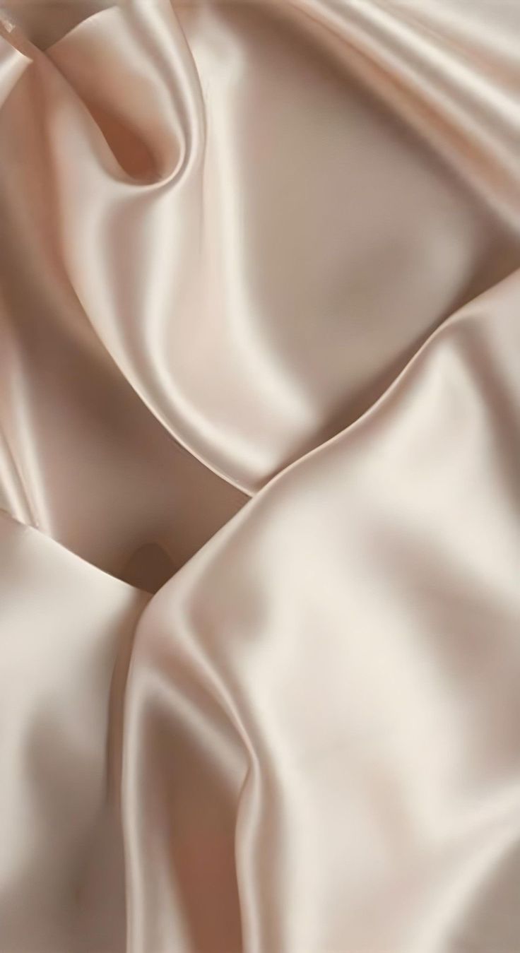 an up close shot of a white satin fabric