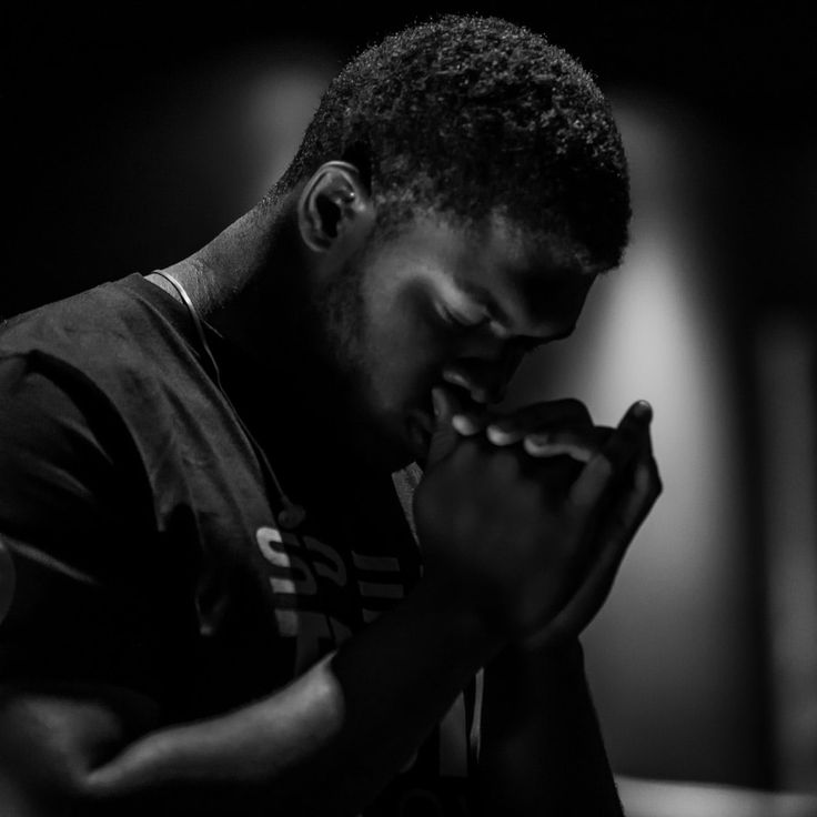 a man holding his hands together in prayer