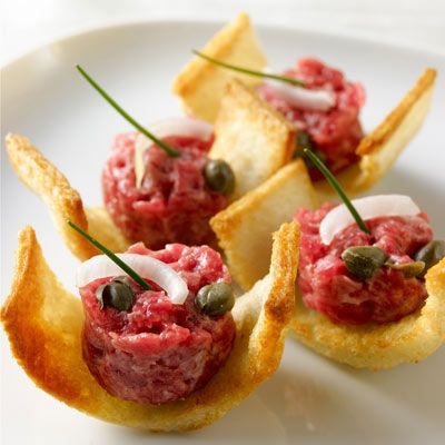 small appetizers are arranged on a white plate