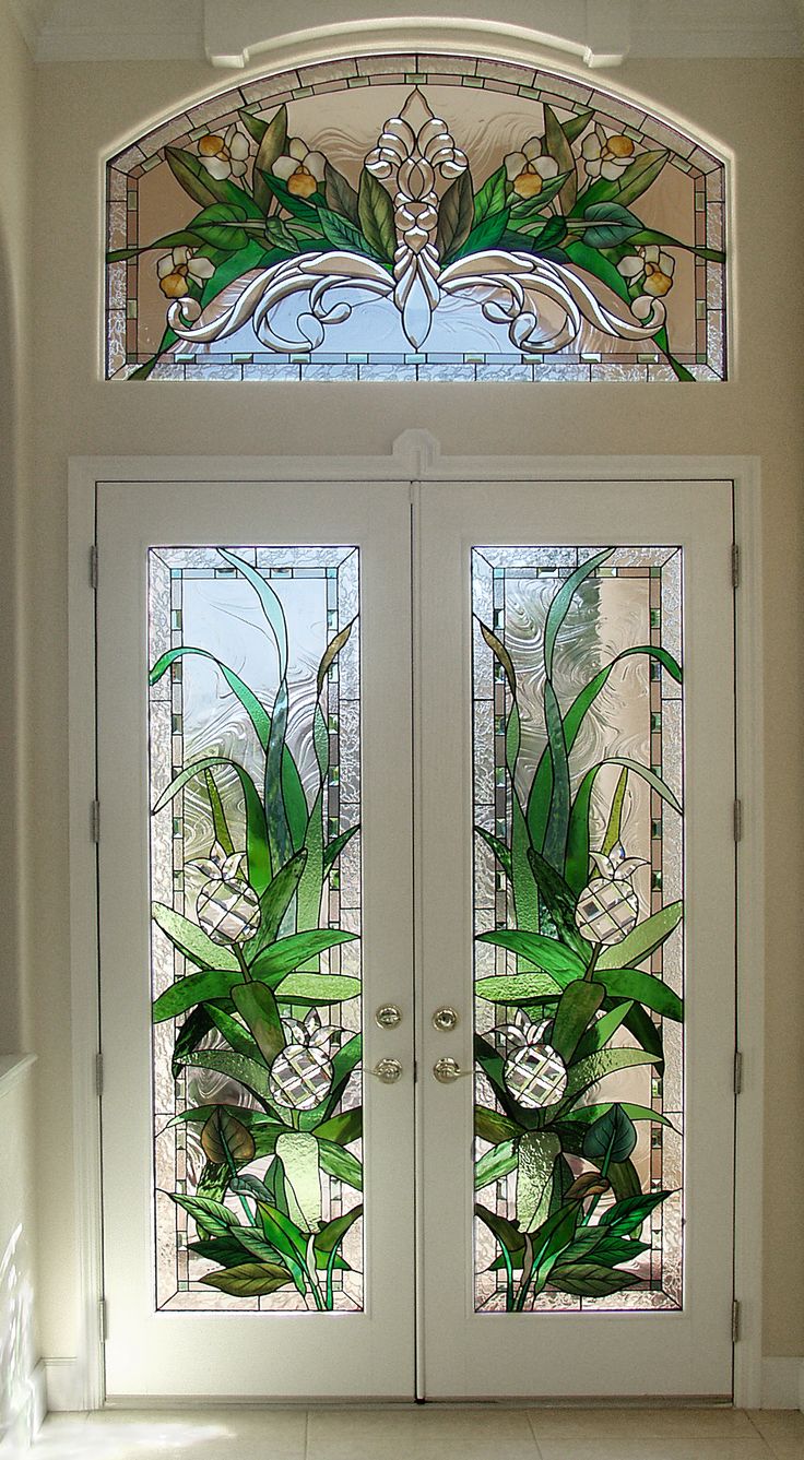 two glass doors with flowers and leaves on them