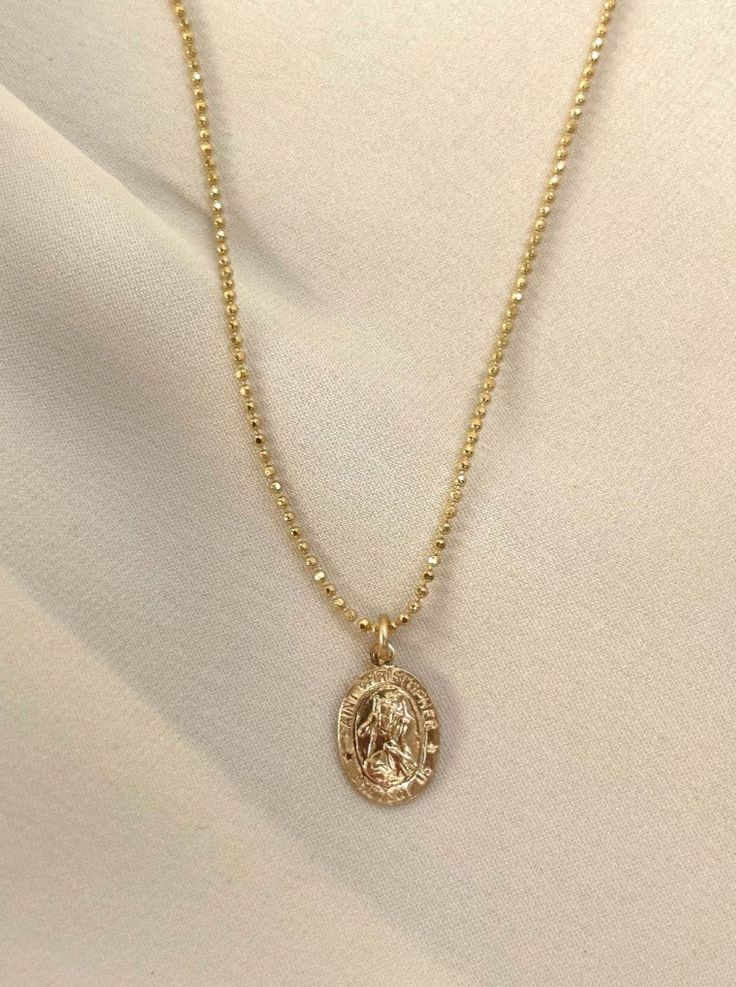 Keep this lucky charm close! Saint Christopher is a symbol for safe travel. Gold plated 16" chain, 2" extender. Gently rubbing the surface of your gold plated jewelry using a soft jewelry cloth helps restore shine. You may clean it with warm, soapy water. Nickel Free Gold Oval Pendant Necklace, Gold Oval Pendant Necklace Nickel Free, Hypoallergenic Gold Pendant Necklace, Everyday Gold Amulet Charm Necklaces, Gold Coin Pendant Charm Necklace, Tarnish Resistant Gold Plated Necklace For Good Luck, Gold Plated Tarnish Resistant Necklace For Good Luck, Gold Hypoallergenic Pendant Charm Necklace, Gold Plated Oval Pendant Charm Necklace