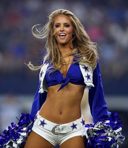 a cheerleader in blue and white is smiling for the camera while wearing her uniform