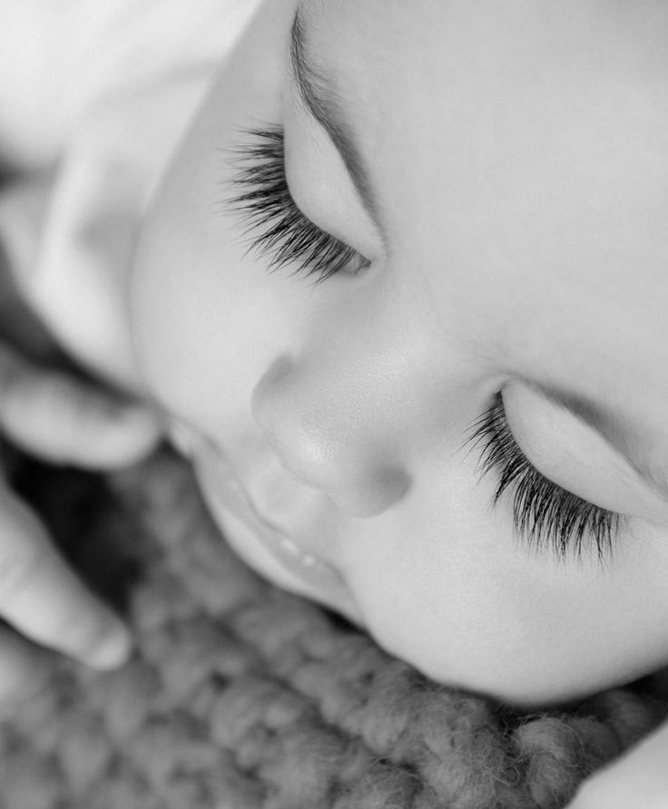 a young child with long eyelashes laying down