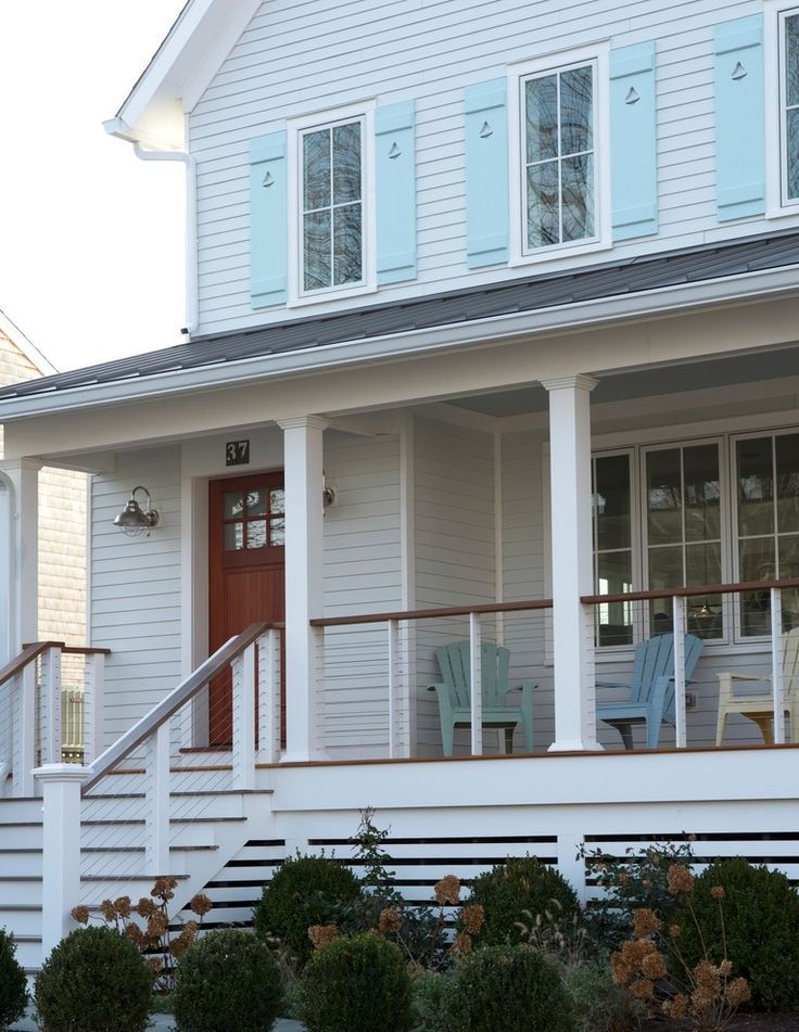 a house with white siding and blue shutters