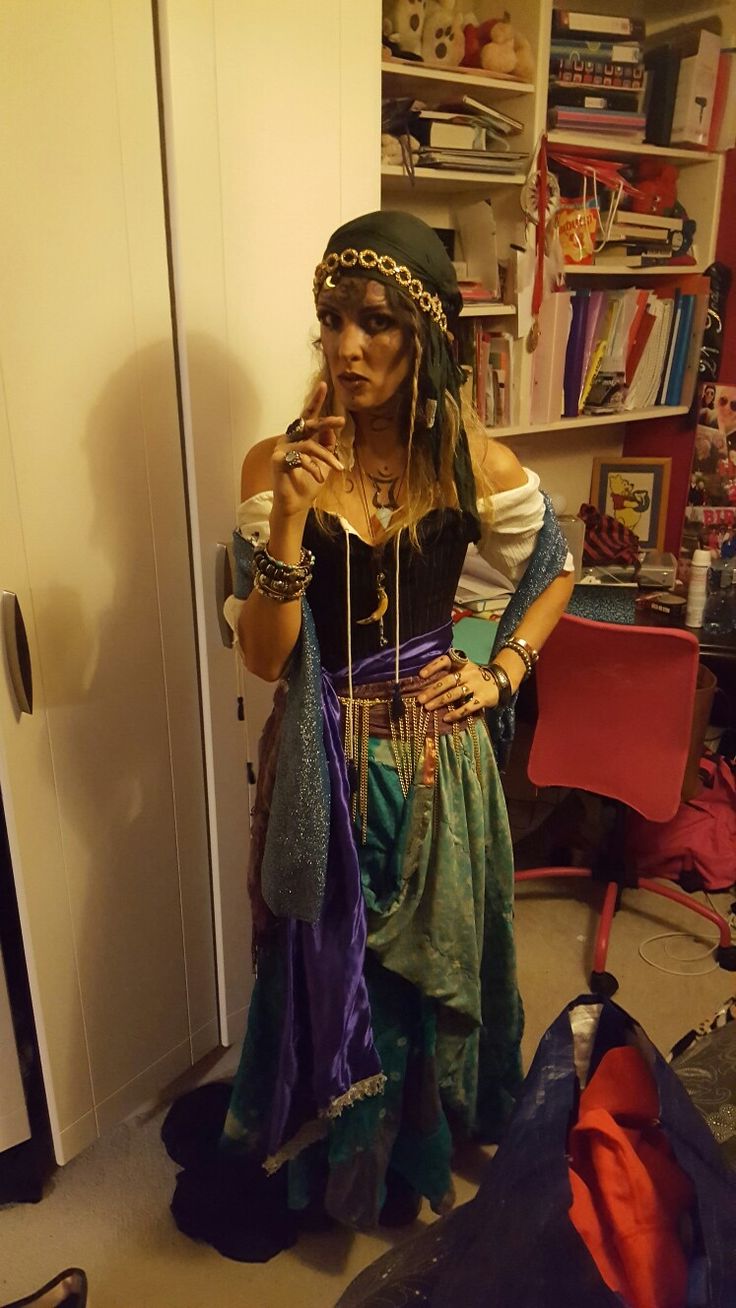 a woman dressed in costume standing next to a closet