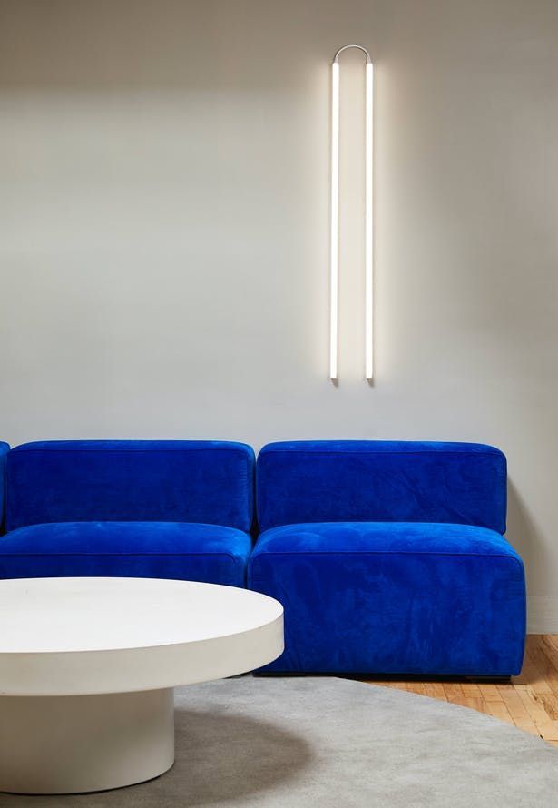 a blue couch sitting next to a white table