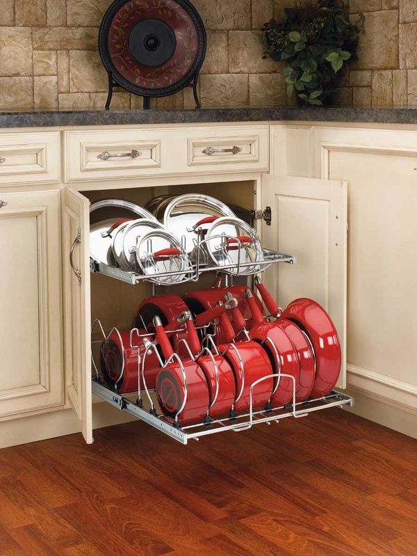 the kitchen space saver is open to show red pots and pans