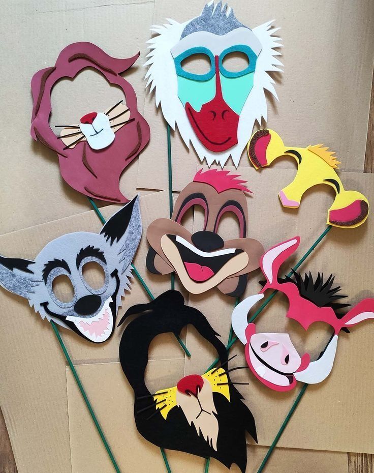 a bunch of masks sitting on top of a cardboard box next to some straws