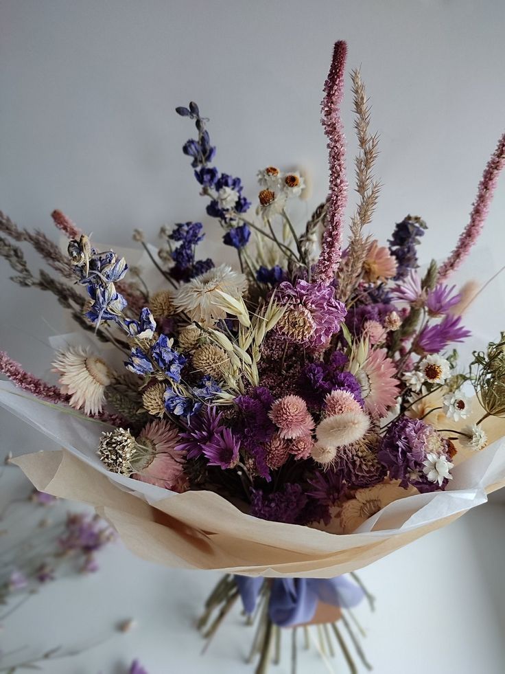 a bouquet of wildflowers and other flowers on a table