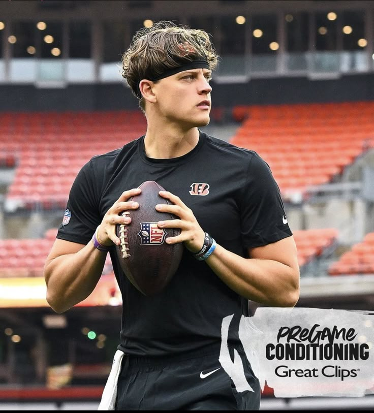 a young man holding a football in front of an empty bleachers with the words freeforme conditioning great clips on it