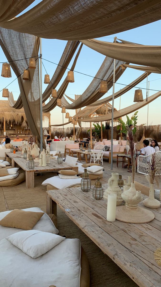 an outdoor dining area with tables and chairs