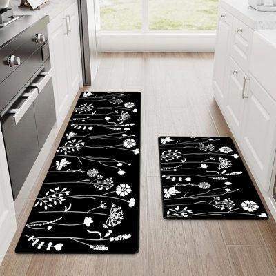 two black and white floral rugs in a kitchen