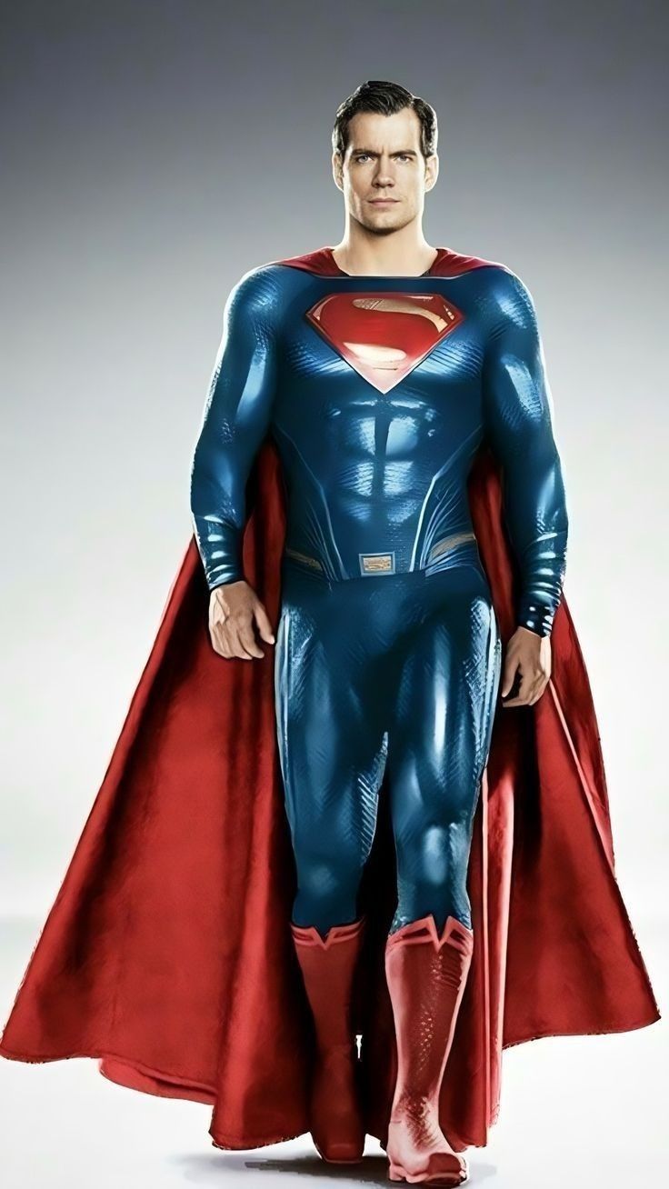 a man in a superman costume standing with his hands on his hips