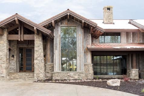 a large house with stone and wood accents