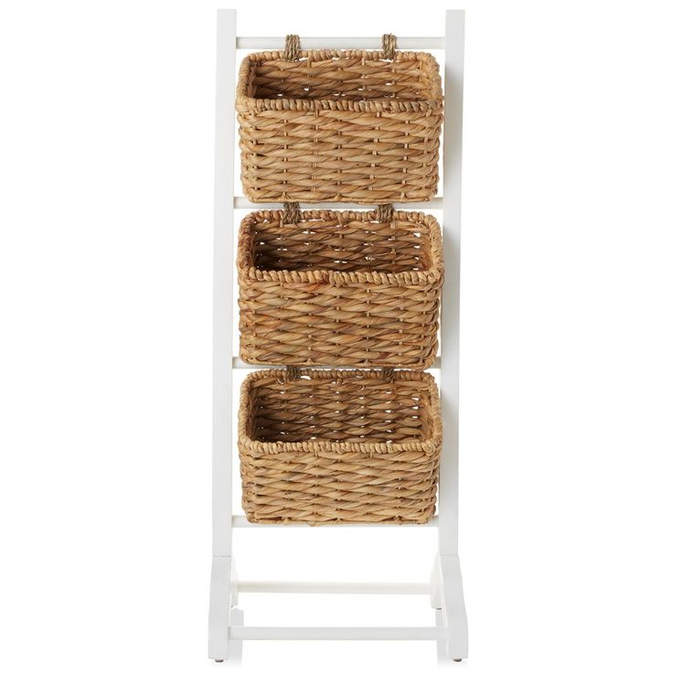 three wicker baskets on a white shelf