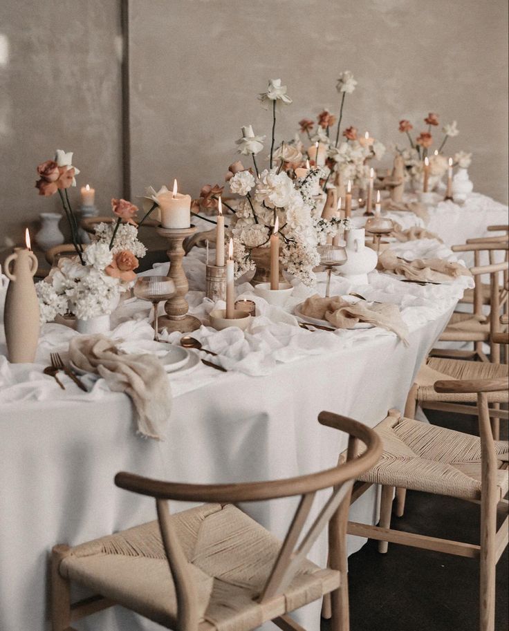 a long table is set with flowers and candles