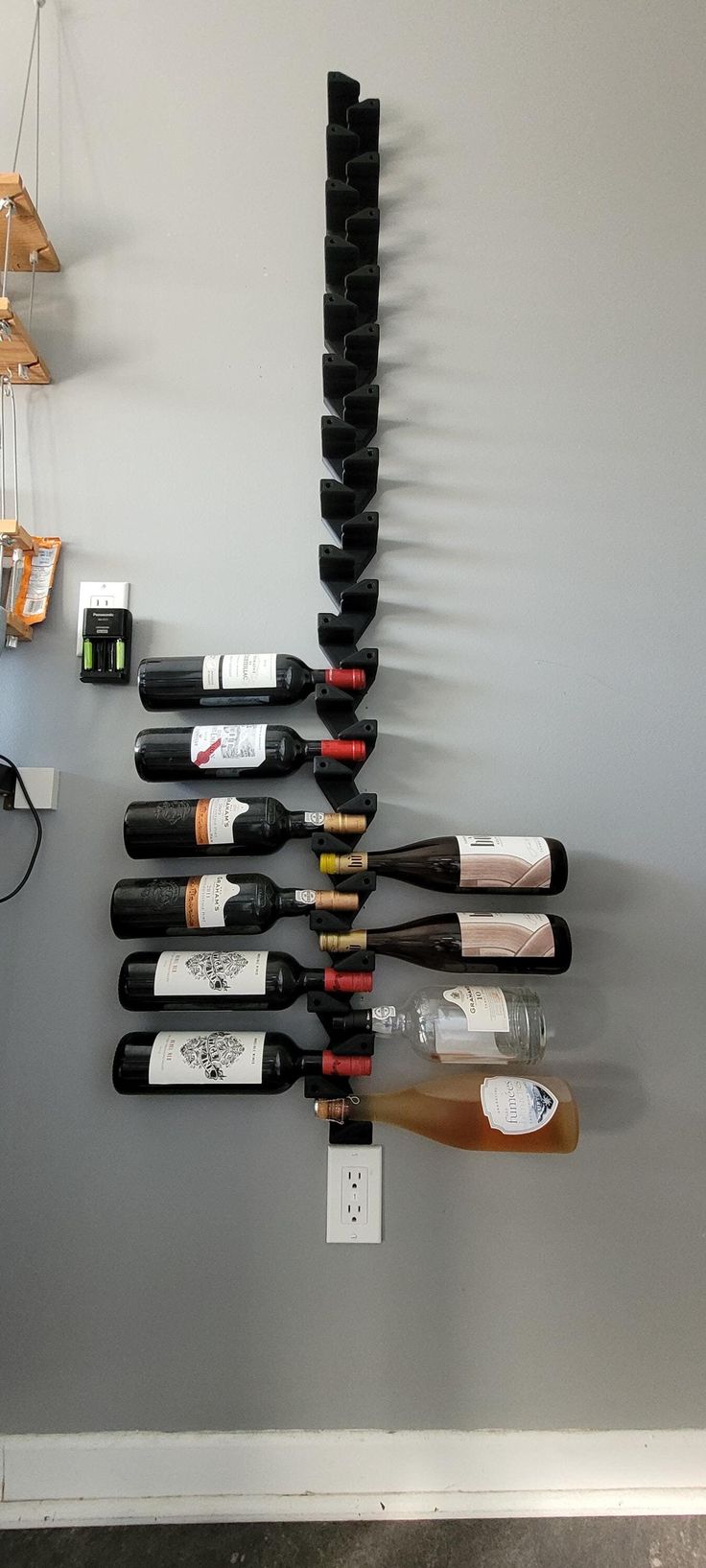 several bottles of wine are hanging on the wall