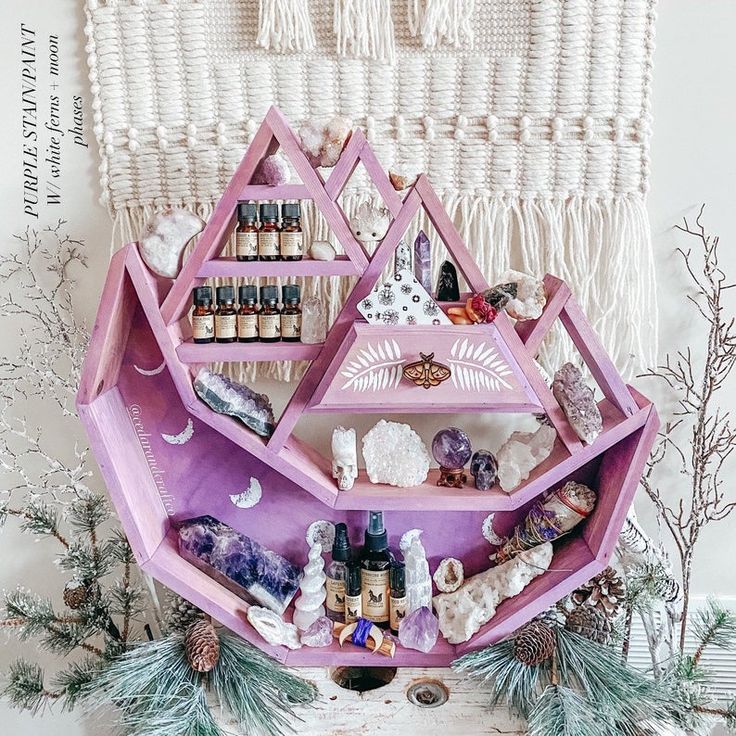 a purple shelf filled with lots of bottles and other items on top of a table