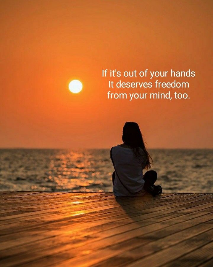 a woman sitting on top of a wooden floor next to the ocean at sunset with a quote about it