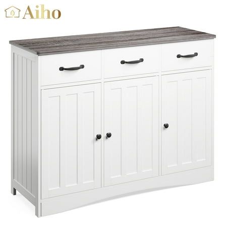 a white cabinet with two doors and three drawers on the bottom, next to a wooden top