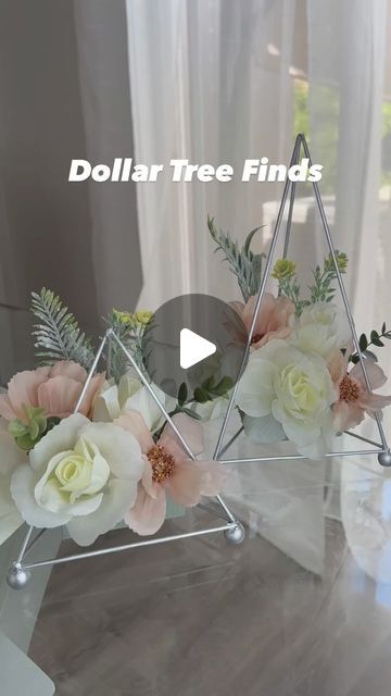 flowers are arranged in triangle shaped vases on a glass table with the words dollar tree finds