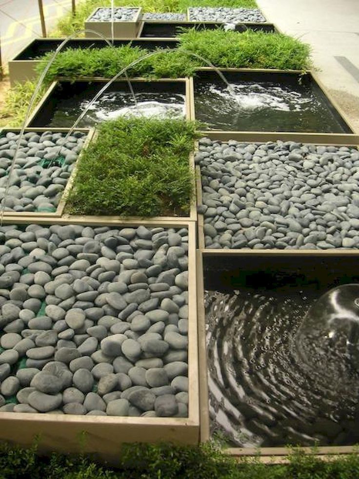 an image of some rocks and water in the ground with grass growing out of them