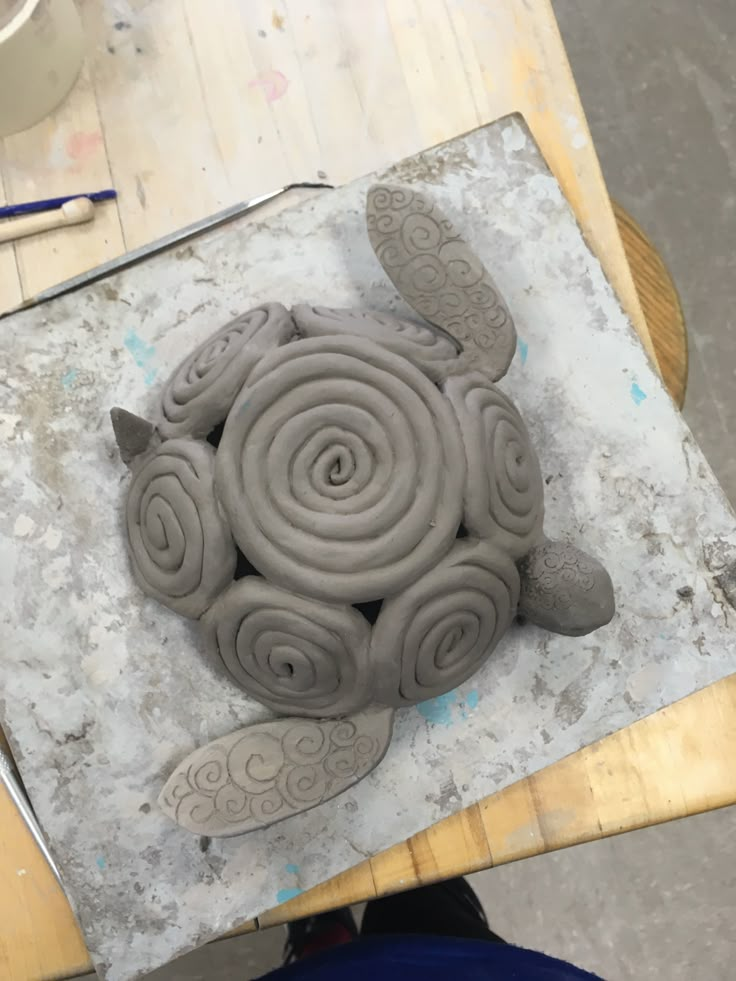 a sculpture made out of clay sitting on top of a table