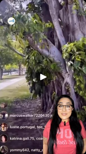 a woman standing in front of a tree