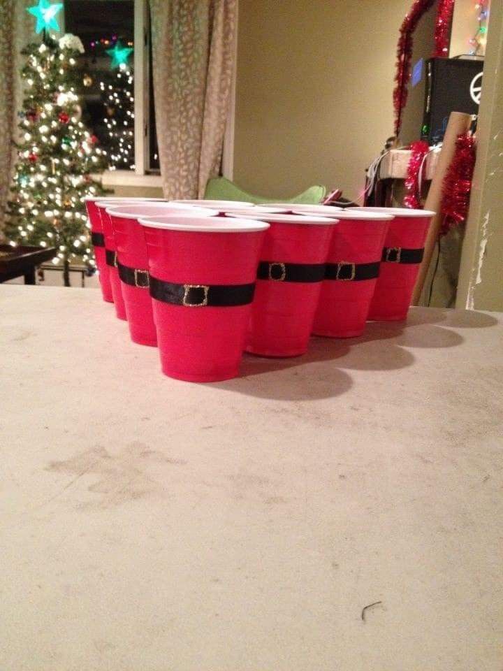 three red buckets sitting on top of a white table next to a christmas tree