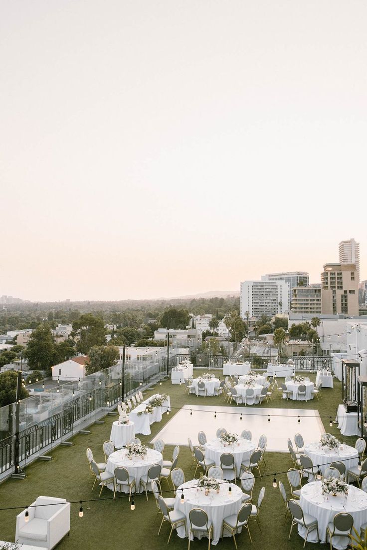 tables and chairs set up on the roof of a building