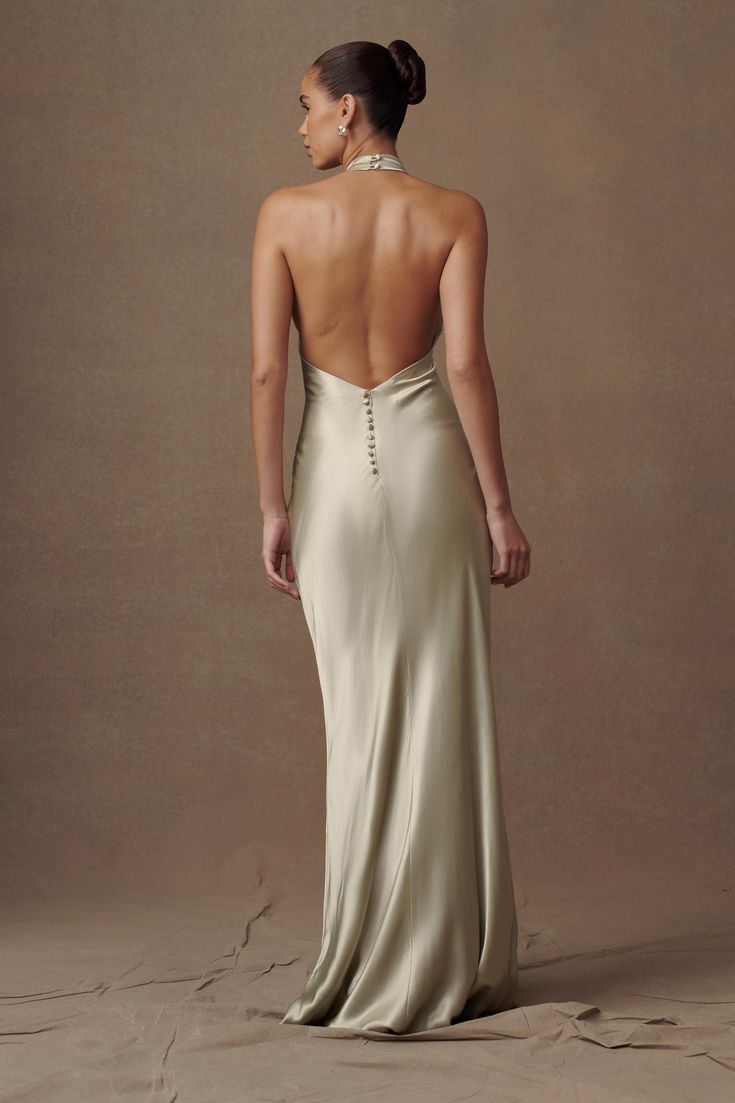 Exude elegance.Make a statement in our ESTHER Iridescent Satin Cowl Maxi Dress, a captivating blend of elegance and allure. Featuring a cowl halter neckline that beautifully frames the décolletage and a low v-back that exudes sophistication, this dress is designed to turn heads. Adorned with self-covered buttons at the back and a side invisible zip for ease of wear, it combines practicality with style. Lined for comfort and a relaxed fit for effortless movement, this dress is the epitome of unde Light Formal Dress, Sage Green Dress Long, Low Back Bridesmaid Dress, Unique Maid Of Honor Dress, Satin Dress Back, Satin Dress Wedding Guest, Slip Dress Prom, Low Back Prom Dress, Satin Dress Maxi