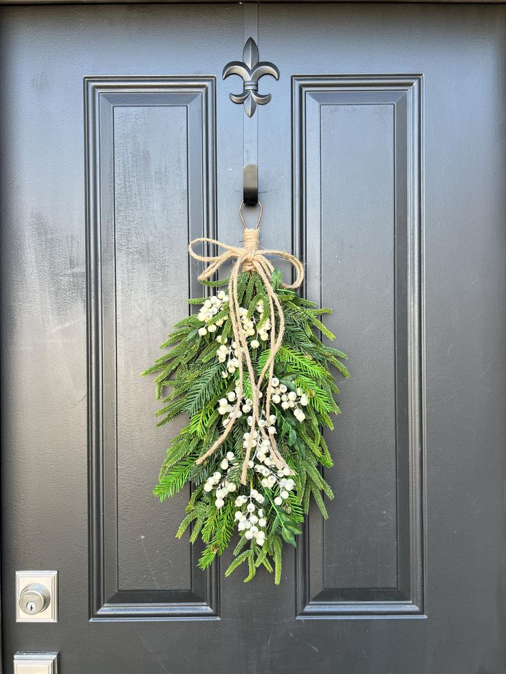 a wreath hanging on the front door of a house