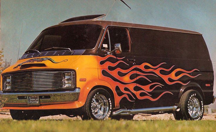 an orange and black van with flames painted on it