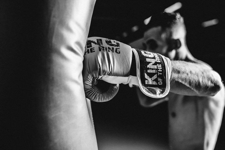 a black and white photo of a man in the ring with his boxing gloves on