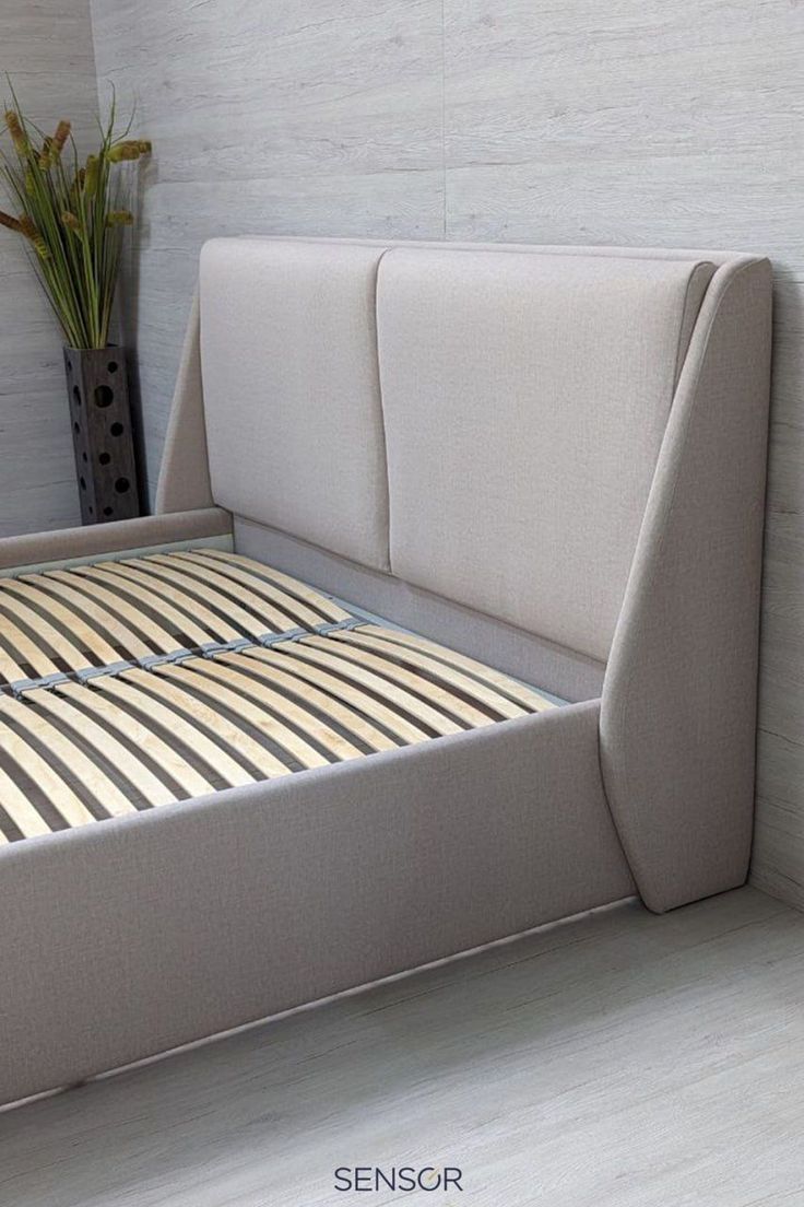 a bed that is made up and has no sheets on the headboard or foot board