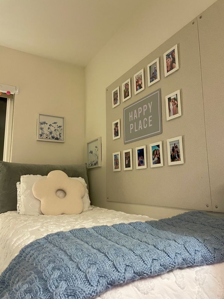 there is a bed with pictures on the wall