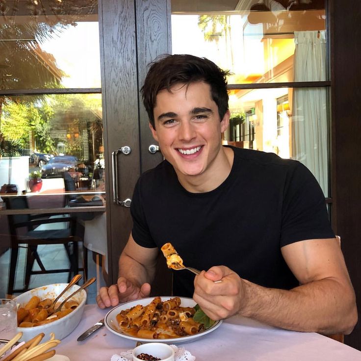 a man sitting at a table with food in front of him