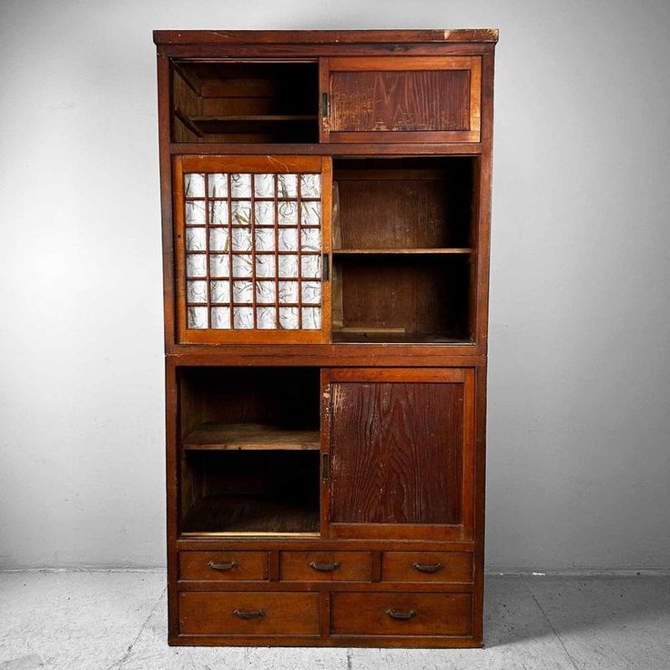 an old wooden bookcase with glass inserts