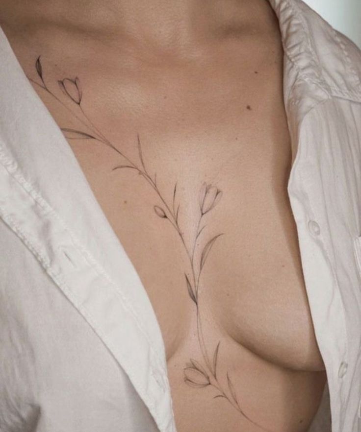 an instagram photo of a woman's chest with flowers on it