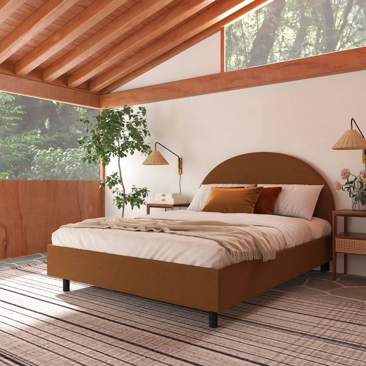 a large bed sitting under a wooden ceiling