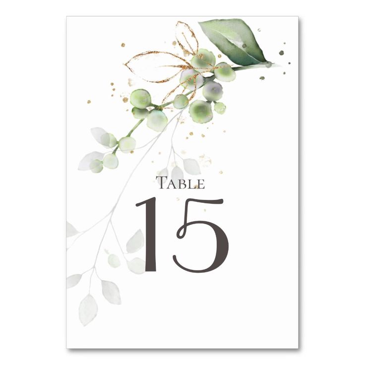 the table number is surrounded by greenery and leaves, as well as an olive branch