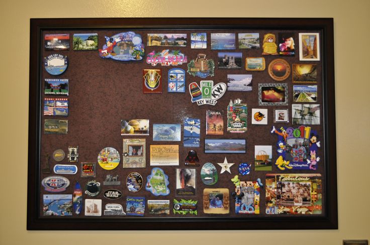 a bulletin board with many different items on it in a room next to a wall