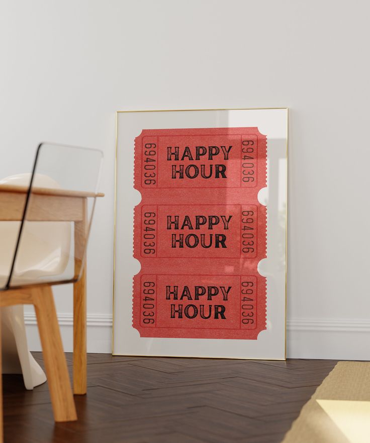 a happy hour movie ticket sitting on the floor next to a wooden table and chair